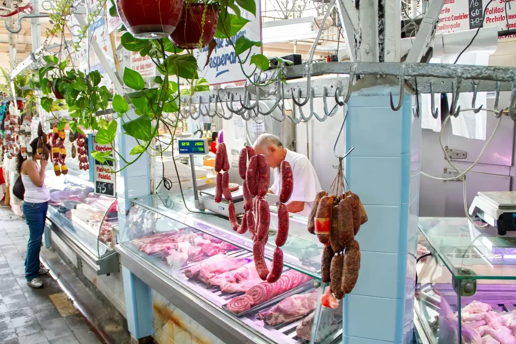 Butcher with sausages at the San Telmo market in Buenos Aires